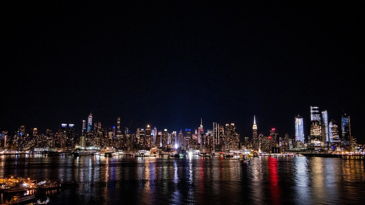 Manhattan skyline at night from across the Hudson on a concert transportation route