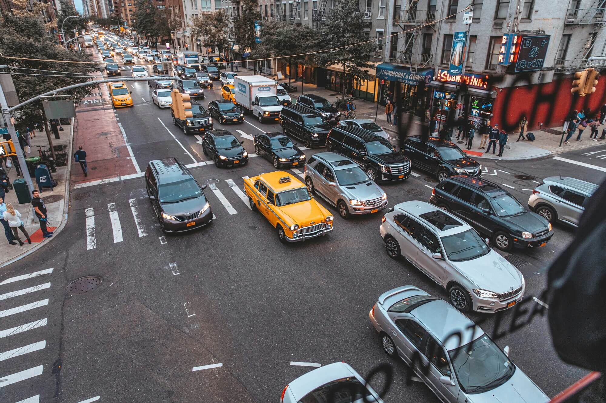 The Flatiron Building rises over Manhattan's Fifth Avenue, a classic destination for NYC town car and point-to-point service.